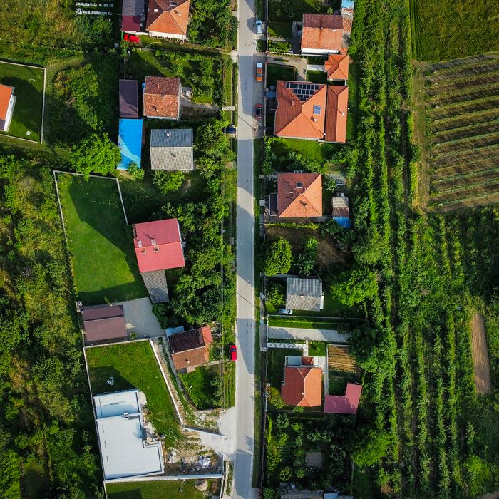 A stunning aerial photo capturing rural houses and lush greenery during summer.
