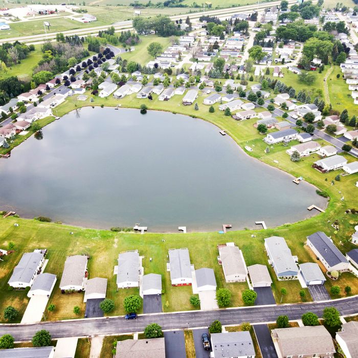 Aerial view of a residential area surrounding a lake in Fond du Lac, Wisconsin, showcasing suburban landscape.